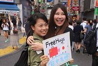 Chinese and Japanese Youth Embrace in Tokyo