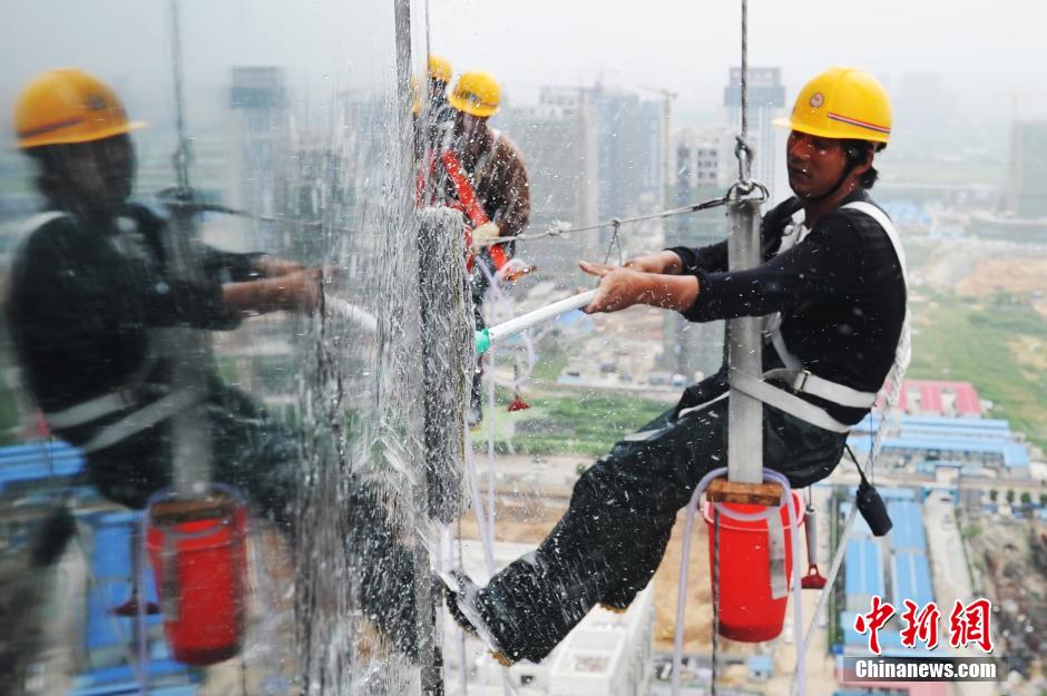 'Spidermen' clean windows of 303-meter-high skyscraper in Nanchang