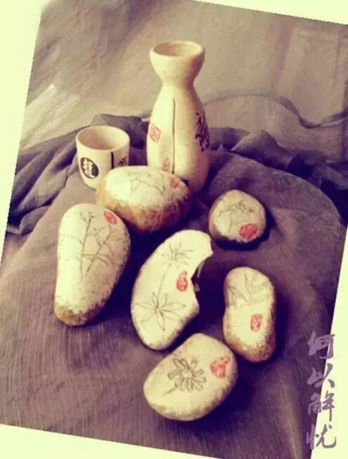 Doctor draws traditional Chinese medicines on stones