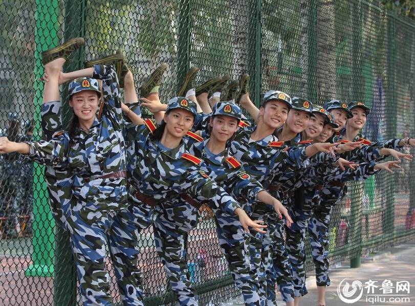 Girls do leg workouts during military training break