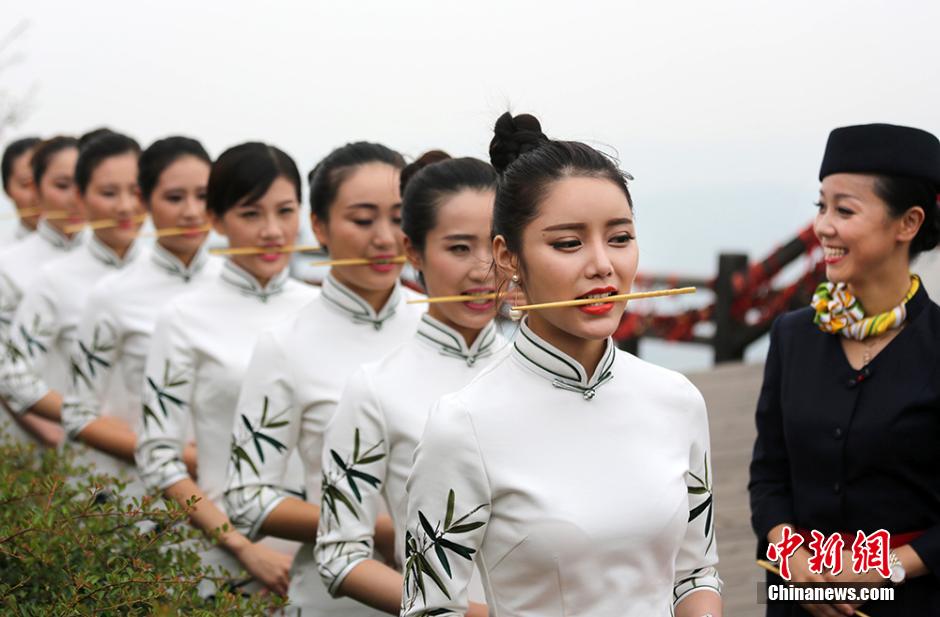 Girls practice smile with chopsticks