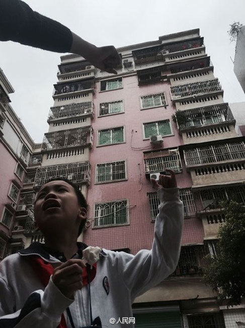 Woman saves baby stuck in window rails on fifth floor
