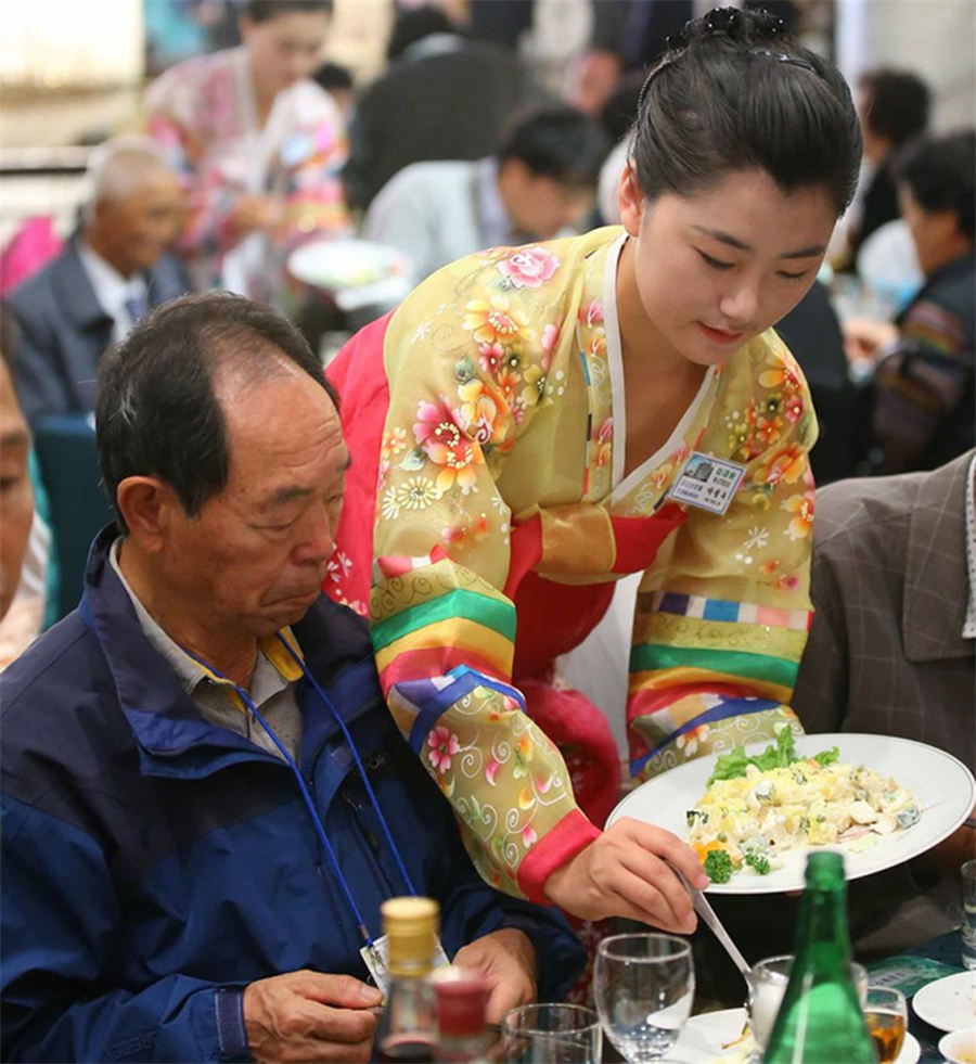 Beautiful DPRK waitresses in Korean families reunion dinner