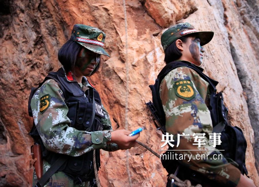 Female soldier of armed police force climbs cliff barehanded