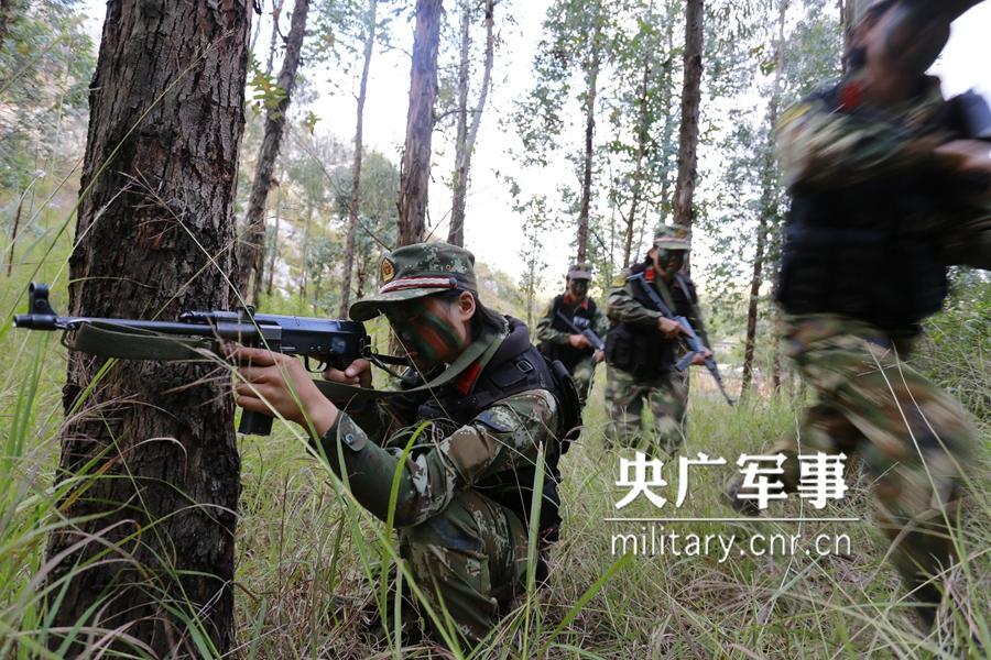 Female soldier of armed police force climbs cliff barehanded