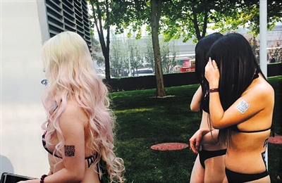 Young women strip to their underwear for a publicity stunt