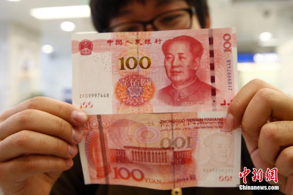 43 armored cash-in-transit vans wait in line to transport new 100-yuan banknotes