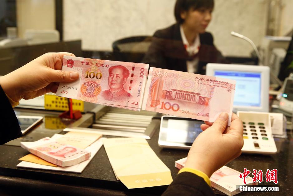 43 armored cash-in-transit vans wait in line to transport new 100-yuan banknotes