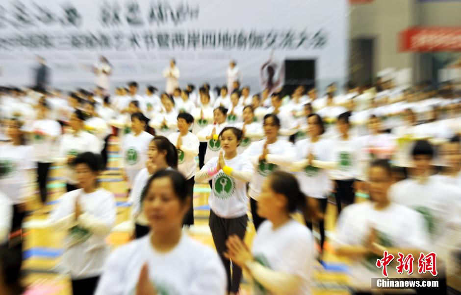 Thousands of people practice yoga in S China