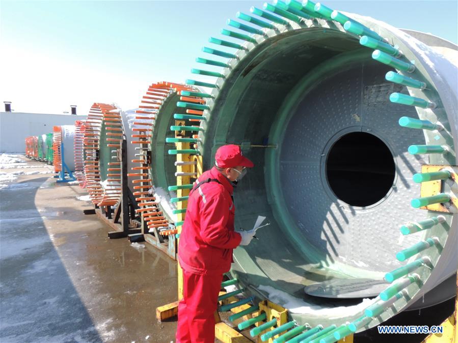 Quality control personnels examine wind-power blades in E China