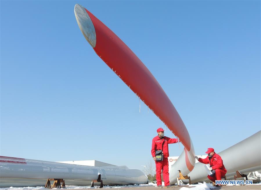 Quality control personnels examine wind-power blades in E China