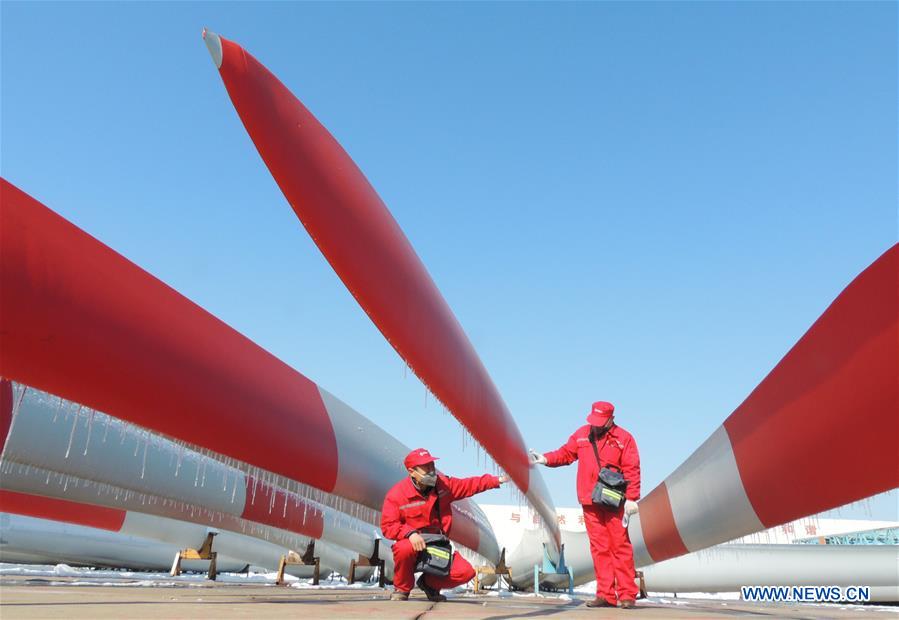 Quality control personnels examine wind-power blades in E China