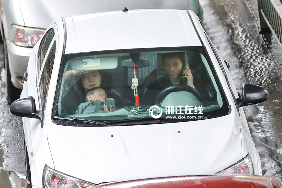 Watch out! Lovers cuddling as they drive a car
