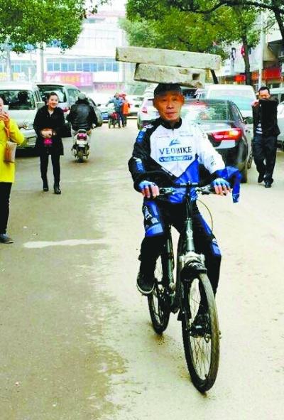 Man rides bicycle with a 34 kg millstone on head for 13 years