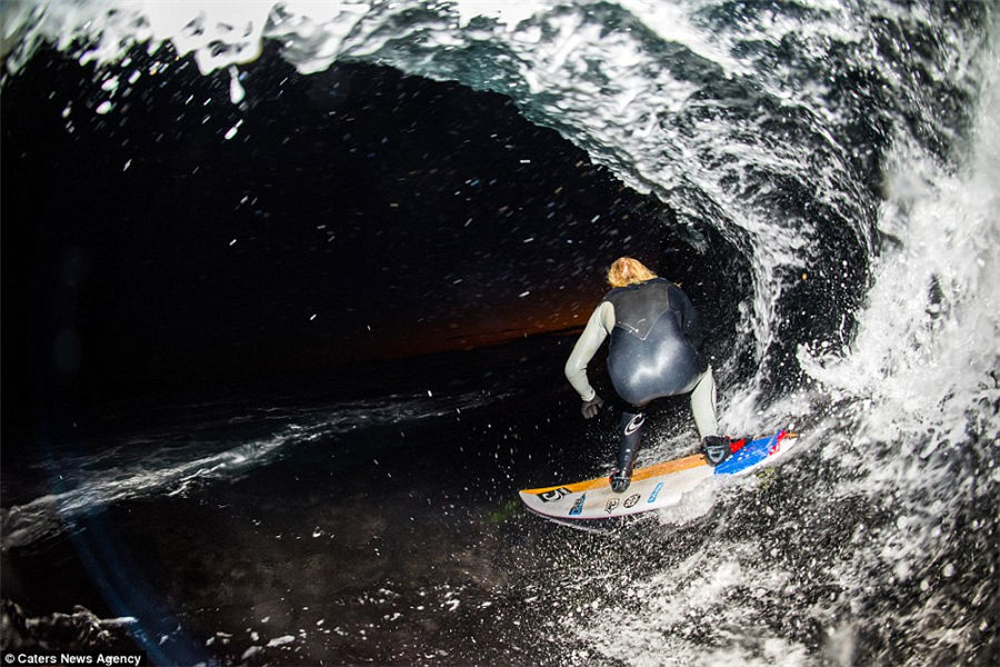 Teenager captures incredible photos of pro-surfers riding huge waves from inside the barrel as he tags along behind them
