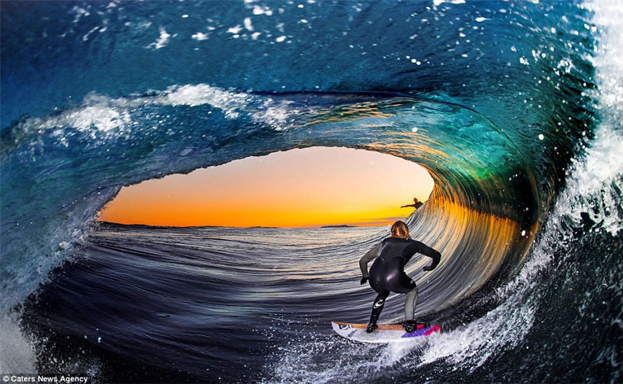 Teenager captures incredible photos of pro-surfers riding huge waves from inside the barrel as he tags along behind them
