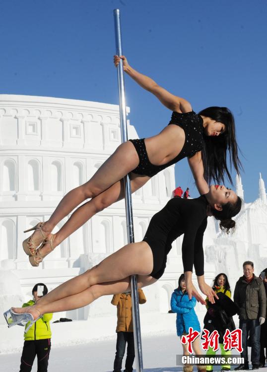 Women perform pole dancing in low temperature