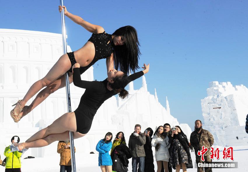 Women perform pole dancing in low temperature