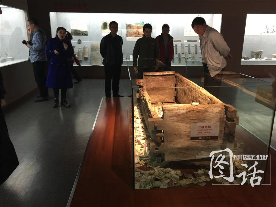 Human remains in museum covered by coins and banknotes thrown by tourists