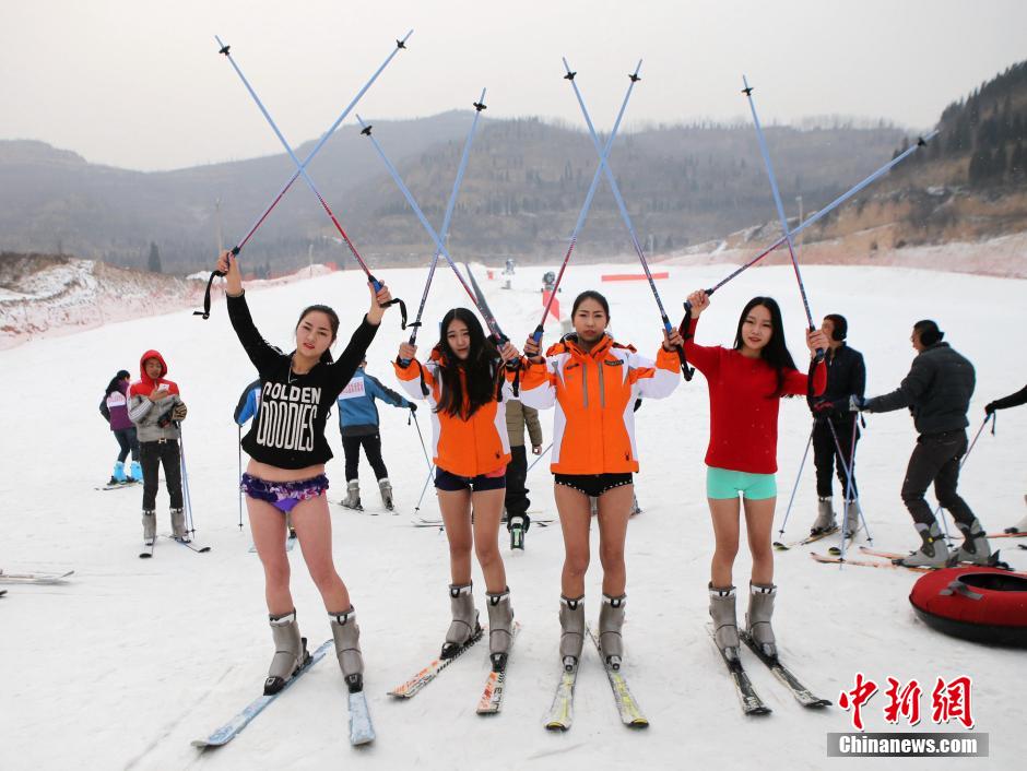 Beautiful skiers wear shorts in snow to mark the No Pants Day