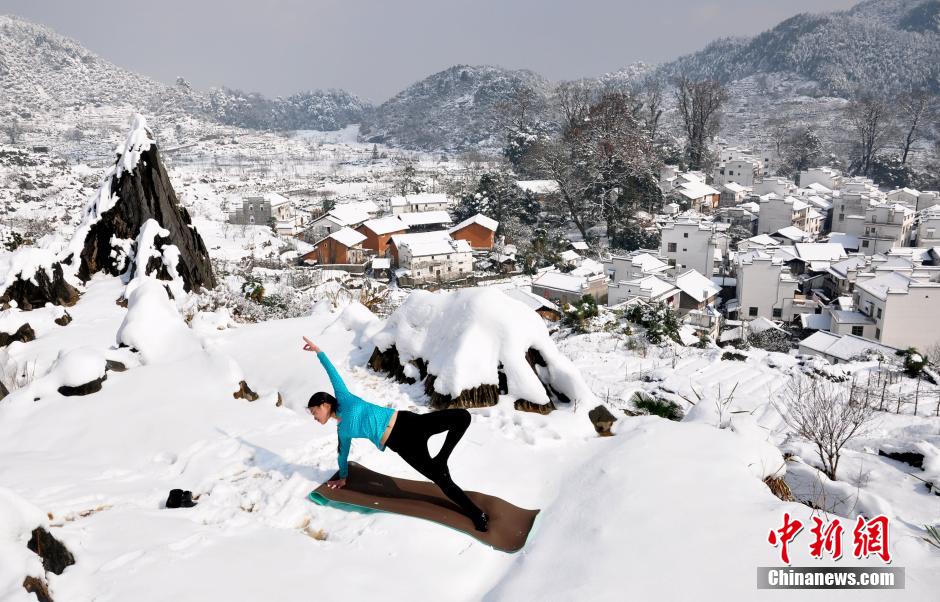 Women enjoy Yoga in snow