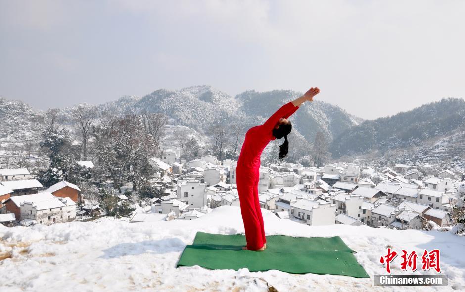 Women enjoy Yoga in snow