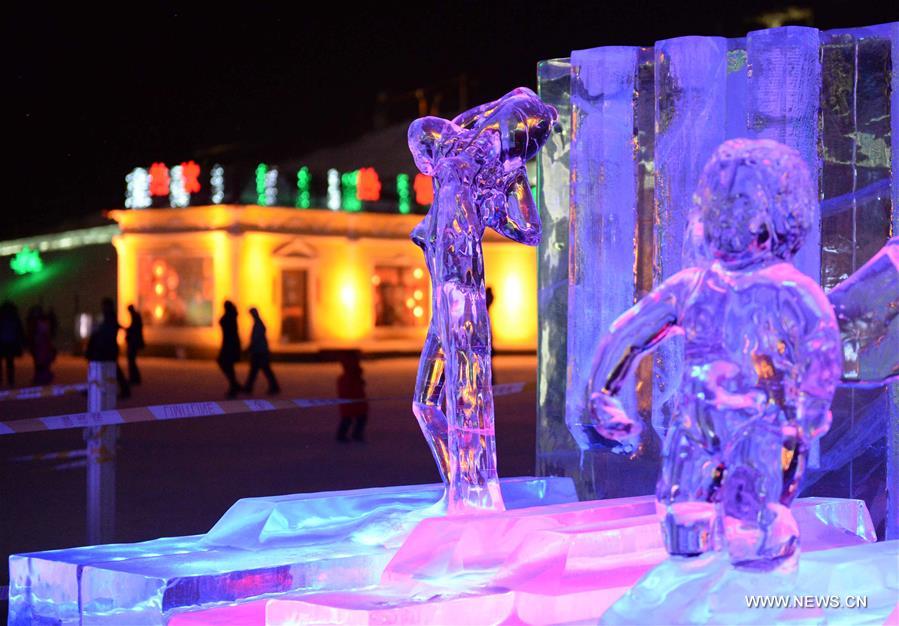 Tourists view shimmering ice sculptures in China's Harbin