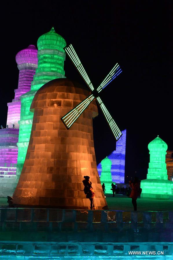 Tourists view shimmering ice sculptures in China's Harbin