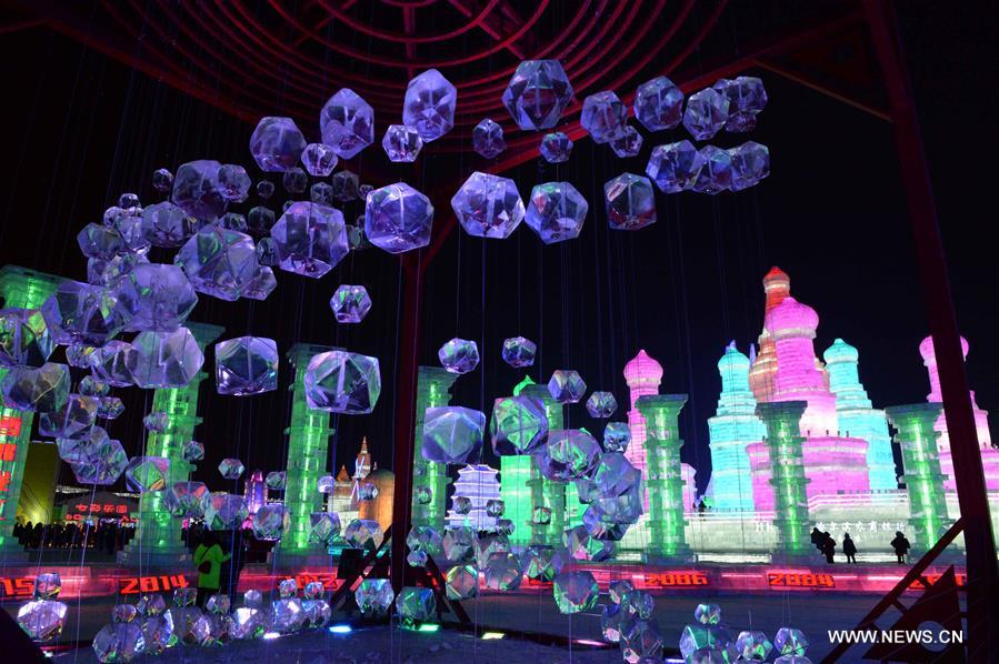 Tourists view shimmering ice sculptures in China's Harbin