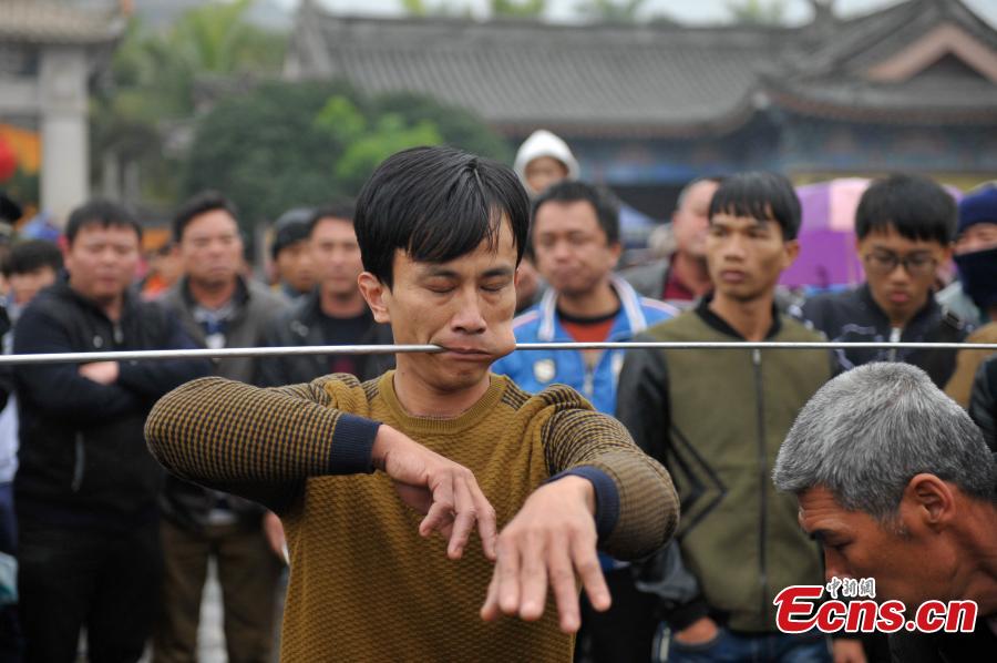 Daring needle stunt a highlight of temple fair