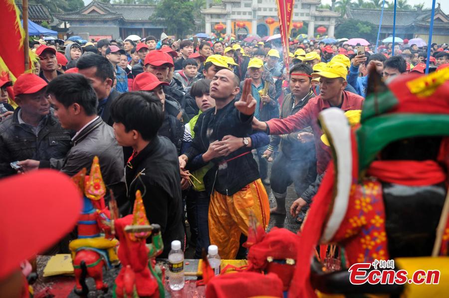 Daring needle stunt a highlight of temple fair