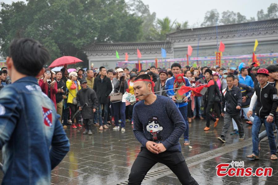 Daring needle stunt a highlight of temple fair