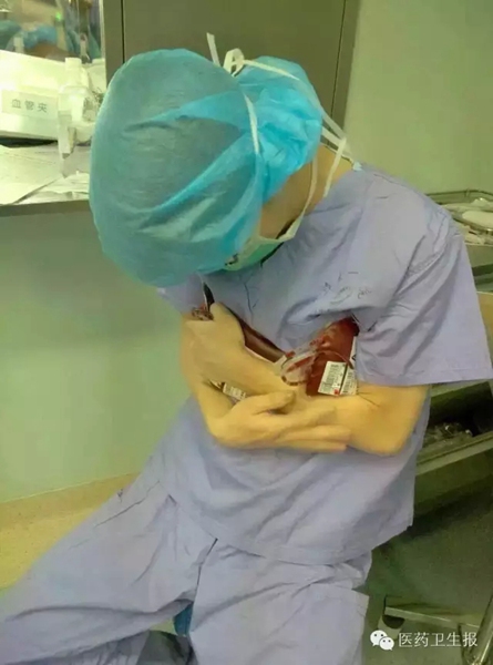 Doctor holds blood bags in his arms to make them warm