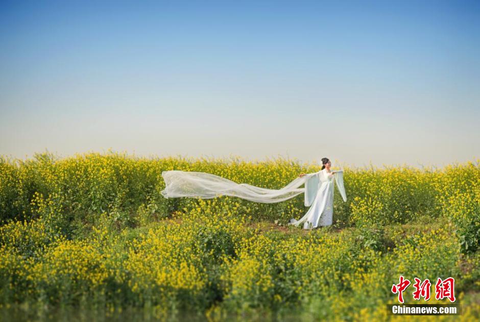 Female official wearing traditional Han costume to promote local tourism