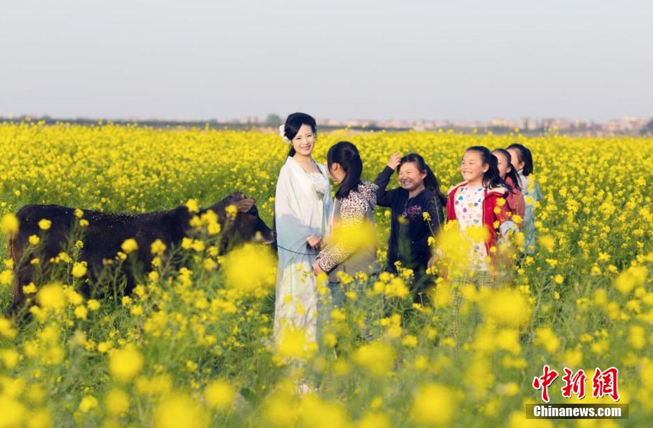 Female official wearing traditional Han costume to promote local tourism