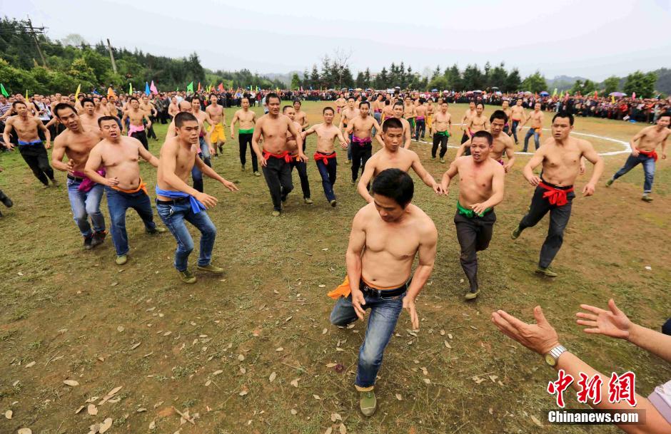 Half-naked men scramble for fireworks in Guangxi