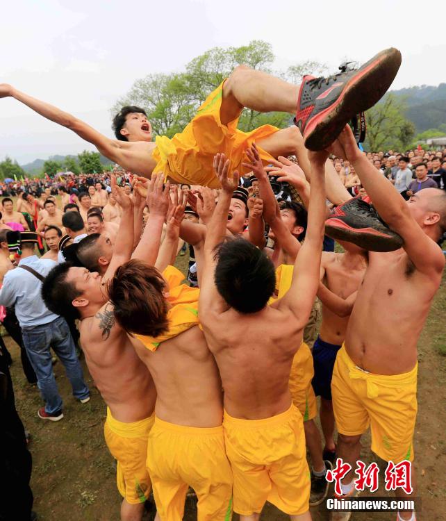 Half-naked men scramble for fireworks in Guangxi