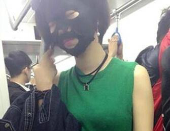 Woman rides subway wearing facial mask