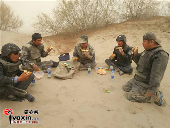 Braving dust and wind, policemen in the desert ride motorcycles to perform duty