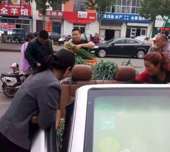 Man sells scallions on his BMW convertible