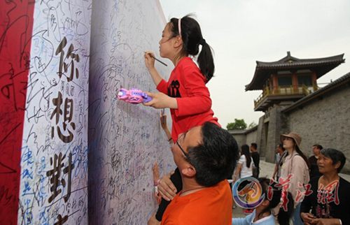 Dad holds me up to add my graffiti