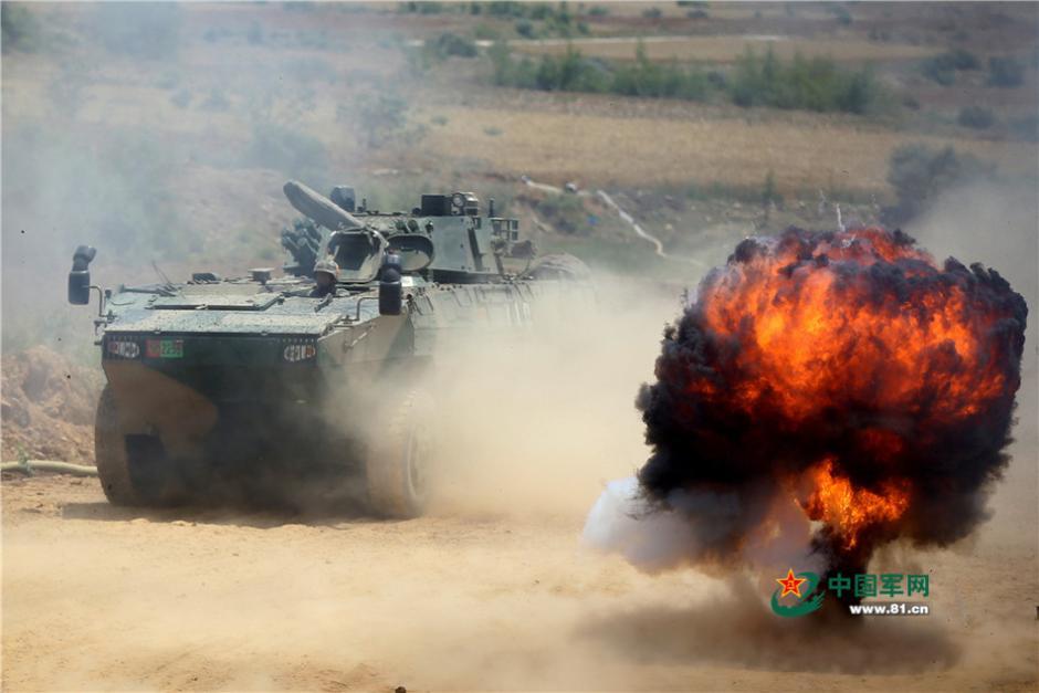 Soldiers driving eight-wheeled infantry fighting vehicles in combat training