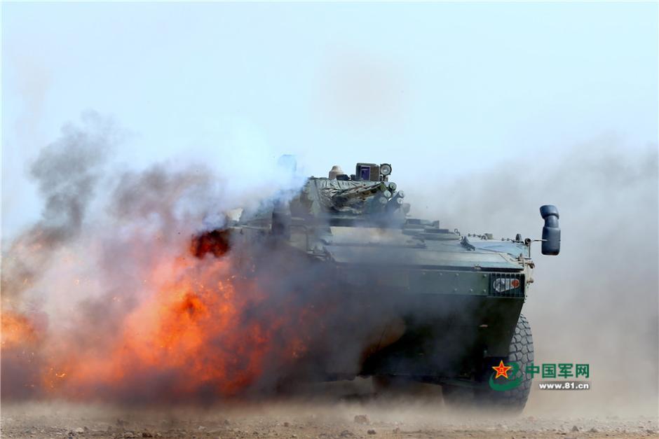 Soldiers driving eight-wheeled infantry fighting vehicles in combat training