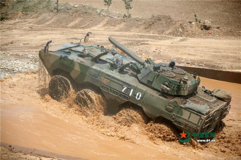 Soldiers driving eight-wheeled infantry fighting vehicles in combat training