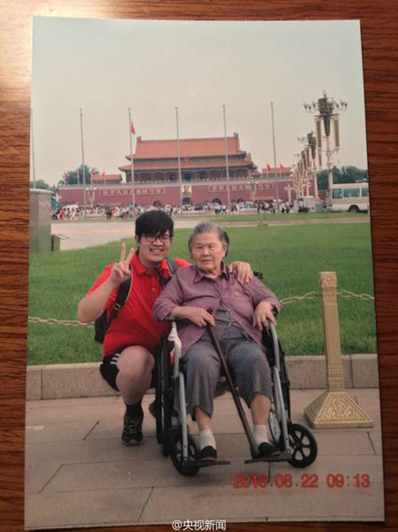 Young man accompanies wheelchair-bound grandmother to Beijing