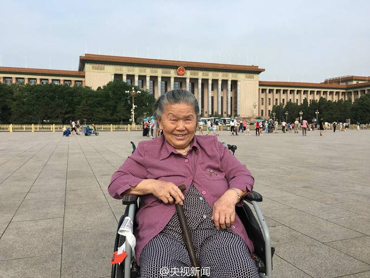 Young man accompanies wheelchair-bound grandmother to Beijing