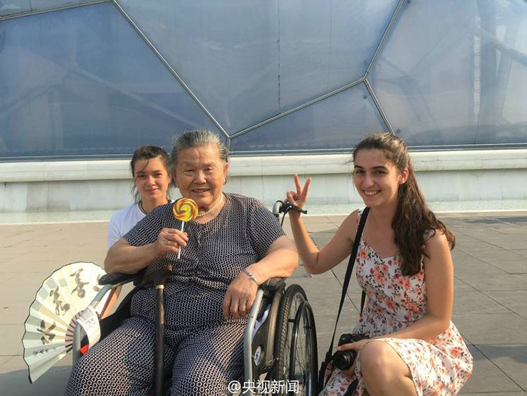 Young man accompanies wheelchair-bound grandmother to Beijing