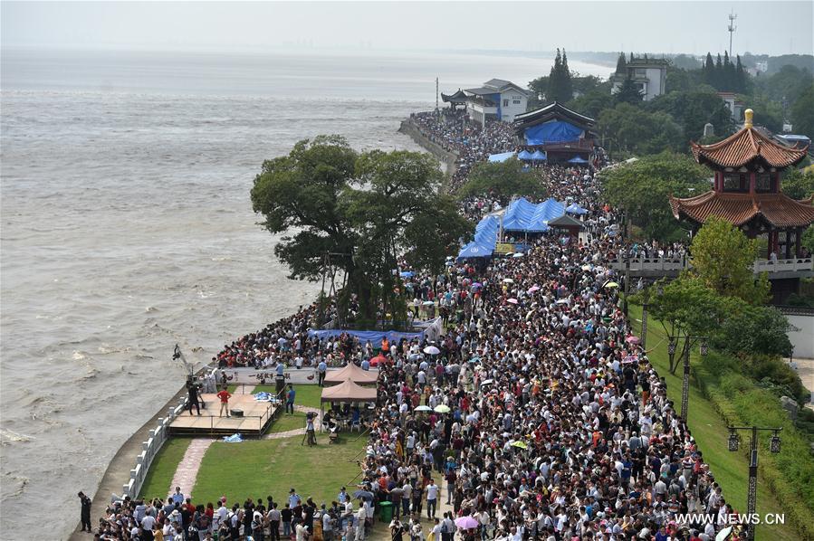 A tidal bore of the Qiantang River arrives in the town at its most heyday on Sept. 18. 