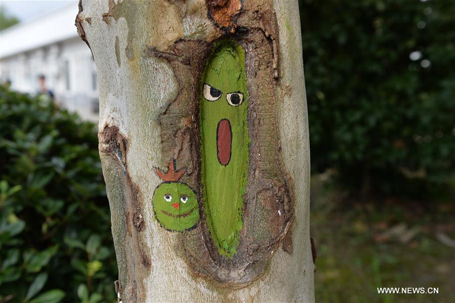 Fifteen art students of the university created 30 tree hollow paintings on campus to greet freshmen as new semester started.