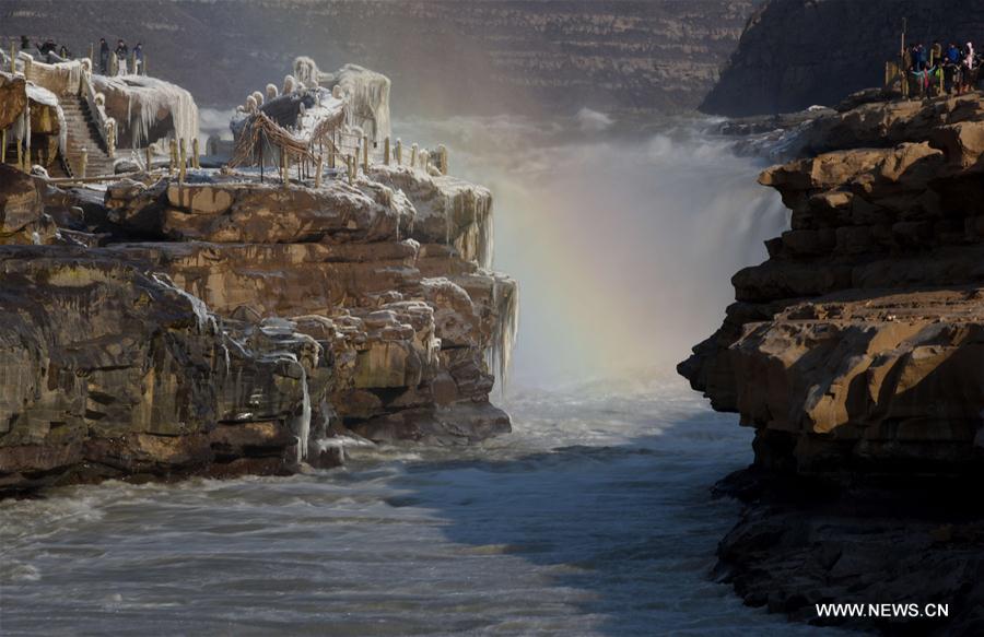 Visitors view frozen Hukou Waterfall on Yellow River